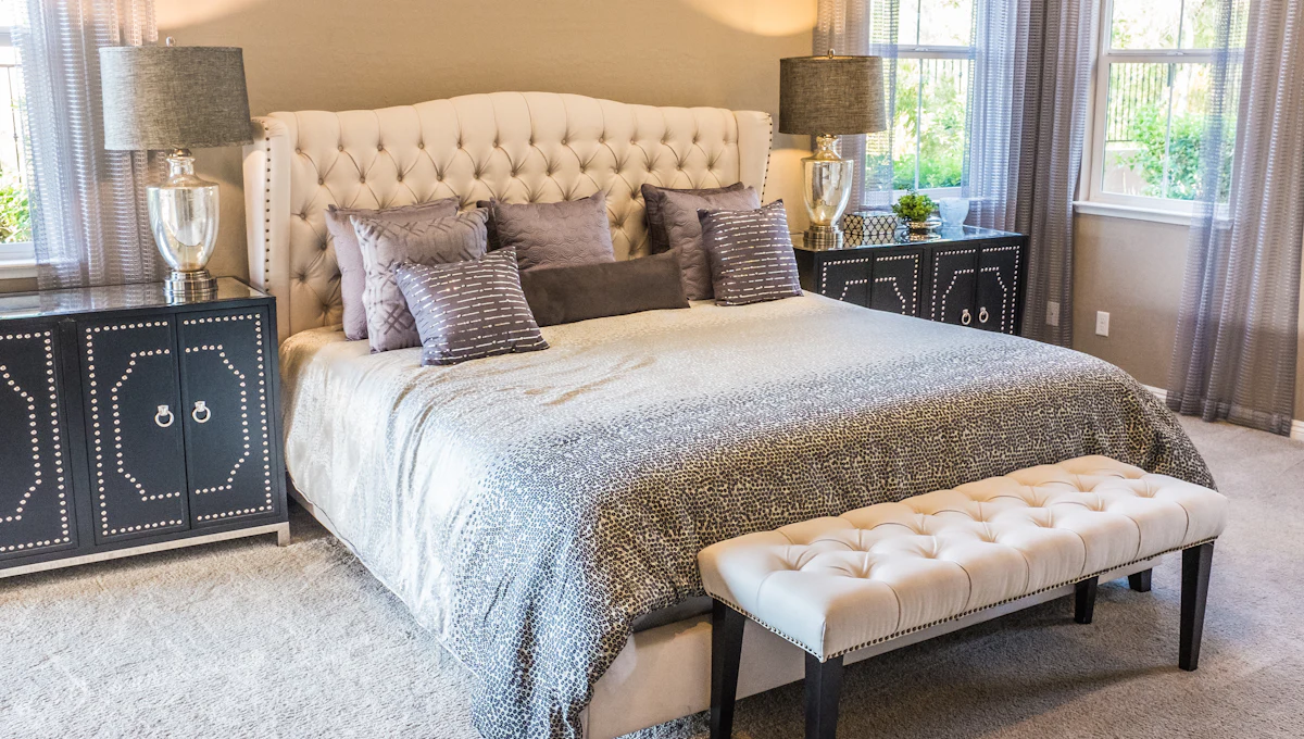 A tidy, made bed in a calm bedroom