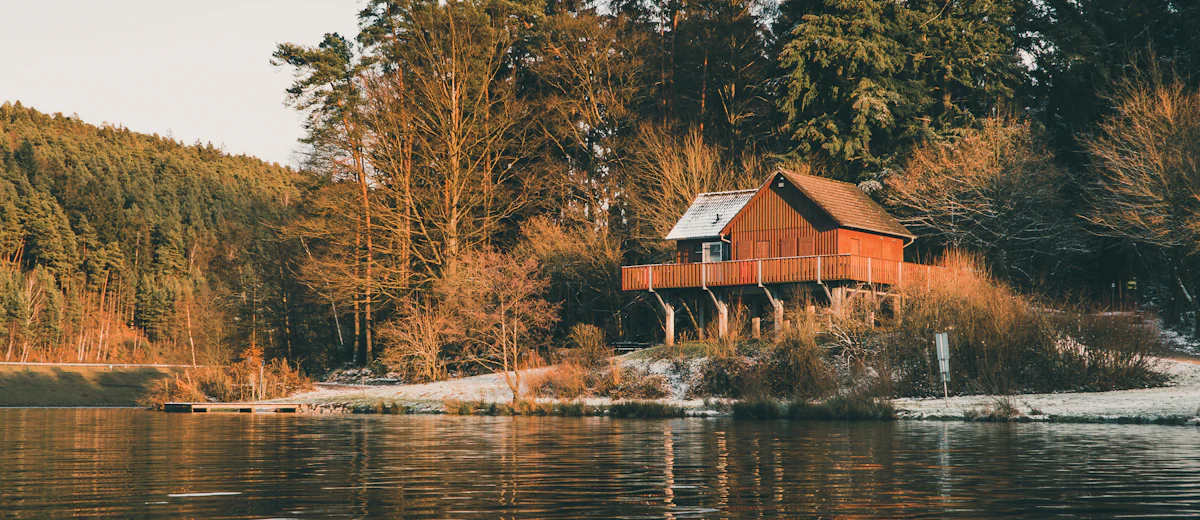 Representative photo: a wooded lakeside home